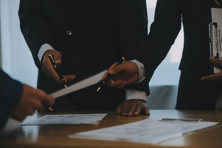 Executives signing documents